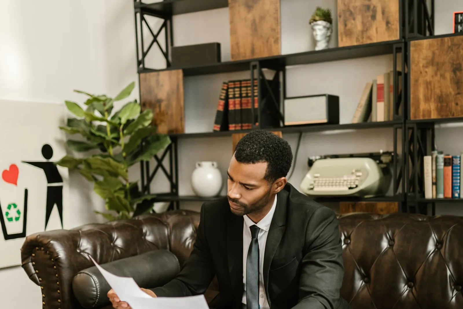 Executive reviewing annual compliance documents at his desk
